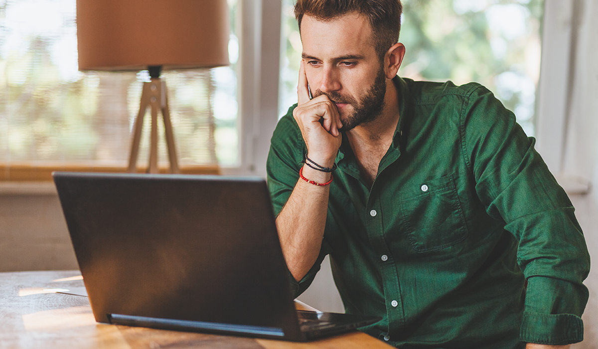 man looking at his computer